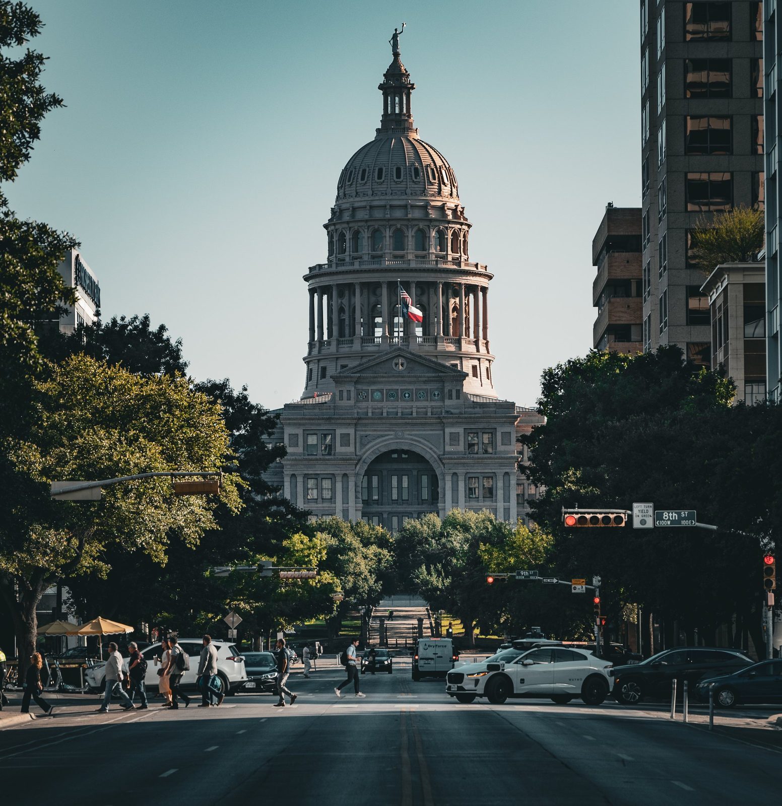 The Texas Capitol at the end of Congress Avenue, framed by live oaks